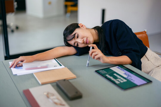 Tired Woman Taking a Break at Office Desk