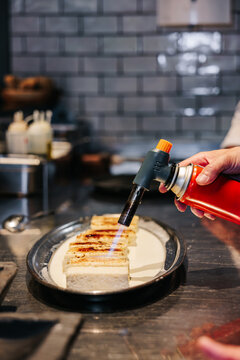 Caramelizing dessert with blowtorch