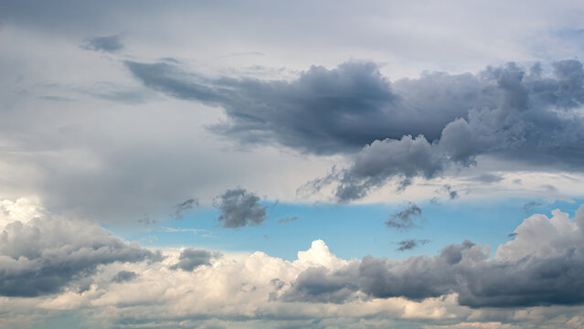 Dramatic Storm Clouds Gathering Over Blue Sky. 16-9 Panoramic Weather Background