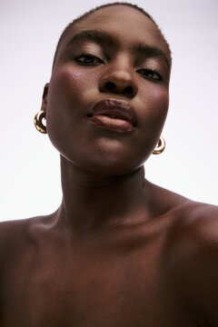 Portrait of a Person With Short Hair and Earrings in Studio Setting