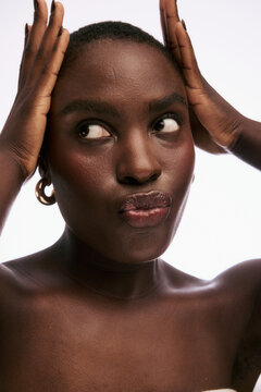 Woman Shows a Thoughtful Expression While Posing in a Studio