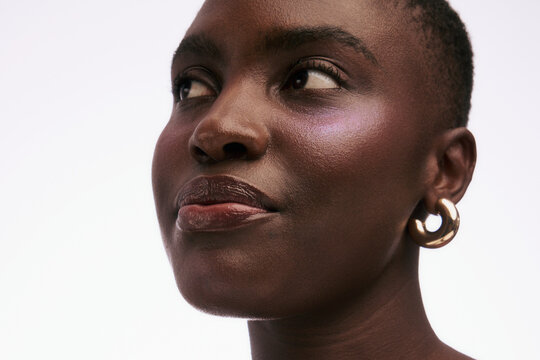 Woman With Short Hair and Earrings Looking Upward