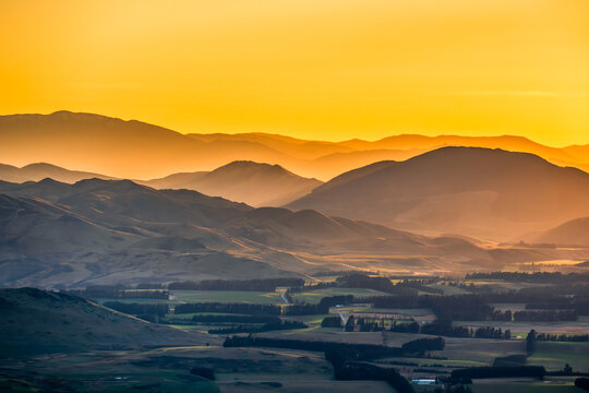 Sunrise over farmland and mountains