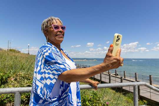 Ocean Portrait Senior Black woman cell phone selfie