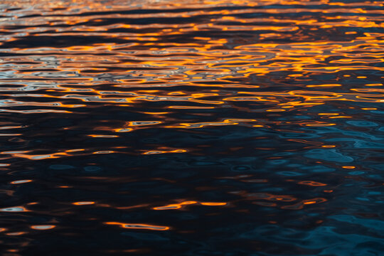 Fiery Reflections on Rippled Water