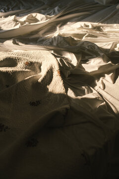 Wrinkled white sheets on a bed