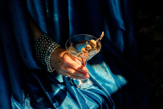 Elegant Martini Cocktail with Olives Against Soft Blue Backdrop