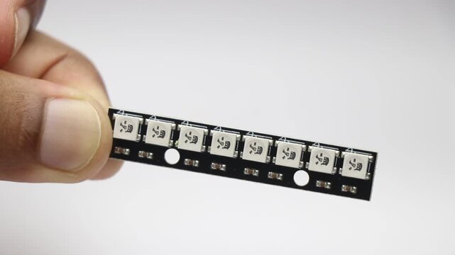 ws2812b addressable rgb led strip on pcb held by tweezers