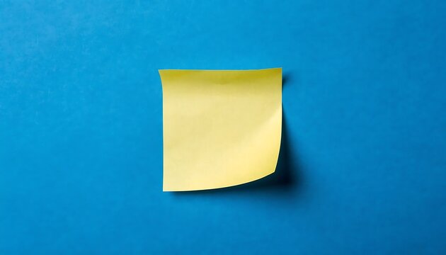 Yellow sticky note on blue background for office reminders and business communication tasks.