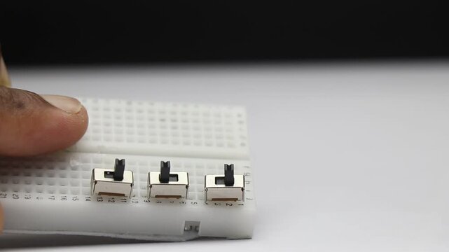 Mini slide switches connected to breadboard. Electronics components on breadboard