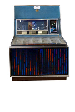A vintage 1968 Seeburg jukebox stands against a white background, featuring a vibrant blue patterned lower cabinet, a selection button interface.