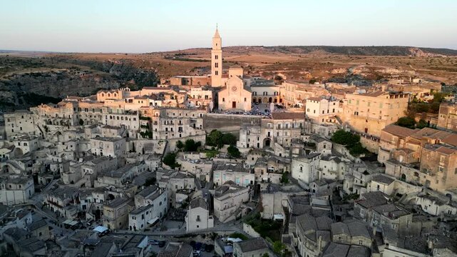 Aerial view of Matera's old city, also known as the Cave City, during sunset, Drone footage taken on 25th of June 2025, Matera province, region of Basilicata, Southern Italy.