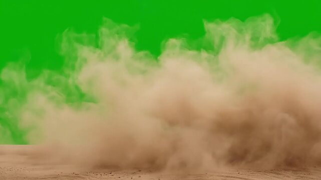 Dust plume blowing across sandy ground on green screen background