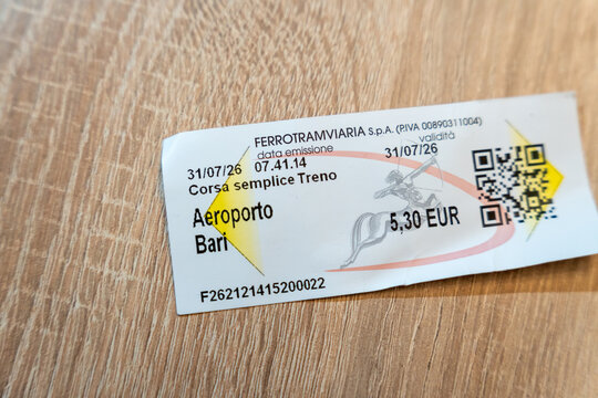 Warsaw, Poland - Sep 5, 2026: Aeroporto Bari train ticket with QR code lying on a wooden table surface