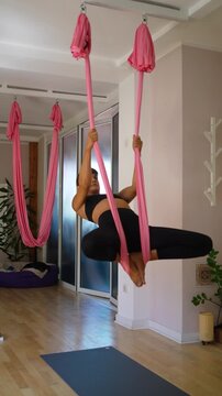 Woman balancing in yoga hammock