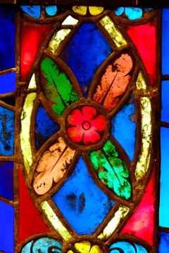 Colorful stained glass window detail with floral pattern