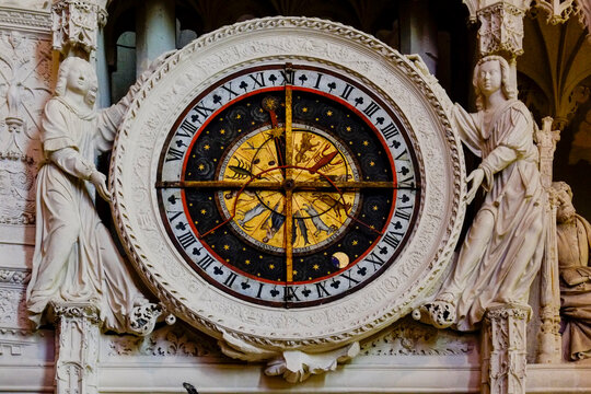 Ornate astronomical clock face on a cathedral facade