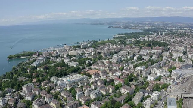 Lausanne, Switzerland. Flight over the central part of the city. The coast of Lake Geneva. Drone footage