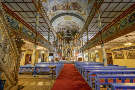 Kosciol pw. Podwyzszenia Krzyza Swietego Blue Pews And Ornate Ceiling In Church. Holy Cross Church