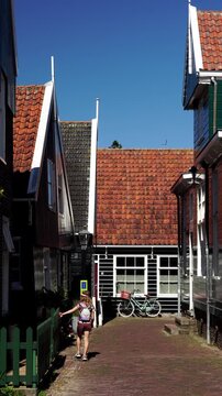 Child walking through a traditional village lane in Marken