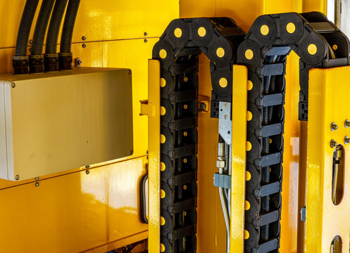  Induastrial machine pattern with yellow tolls and steel cable elements of industry production line on a factory. Manufacturing concept background for workplace desing .