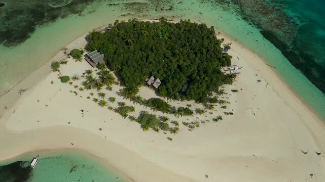 Aerial drone view of Inaladelan Island in Port Barton, Palawan, Philippines, featuring a white sand beach and crystal-clear tropical waters.