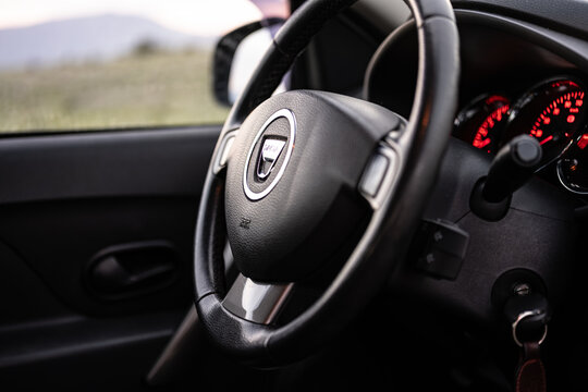Detailed interior view focusing on the dark dashboard and illuminated red instrument cluster of a reliable sports utility car illustrating modern automotive interior design and technology features.