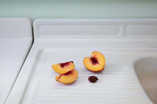 Sliced peach on white counter