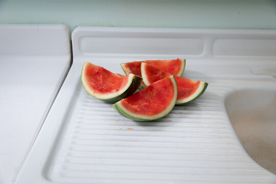 watermelon rinds on white metal counter 