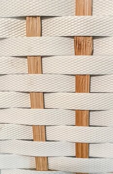 Close Up White Plastic Strap and Wood Wicker Texture
Description: A detailed macro view of white textured plastic strapping tape woven together with vertical natural wood strips, creating a clean b


