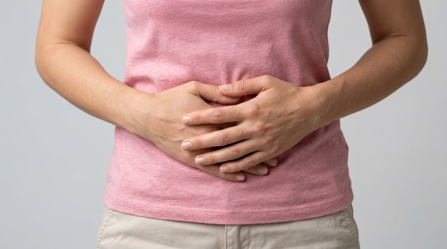 Woman experiencing pelvic discomfort and abdominal pain related to cervical cancer symptoms.