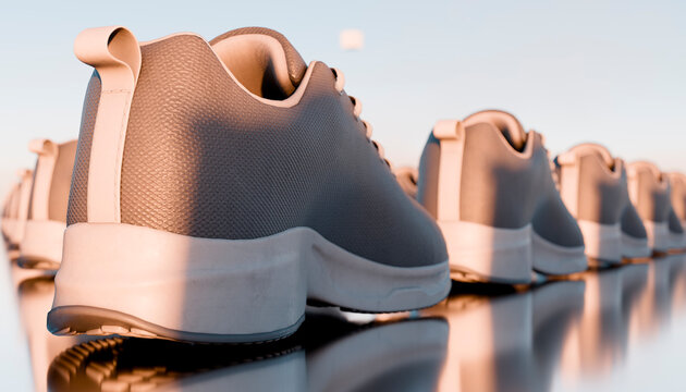 Athletic shoes lined up in a row with reflective surface in studio