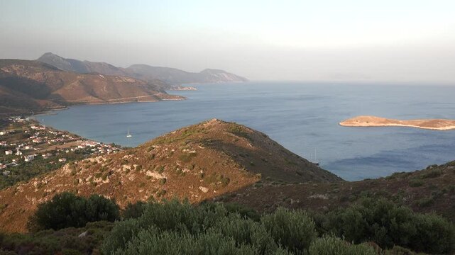 Clear bays and villages line the Datca peninsula, creating a bright Aegean shoreline scene. Village homes, blue water, and Mugla coast form a scenic Turkish settlement view.