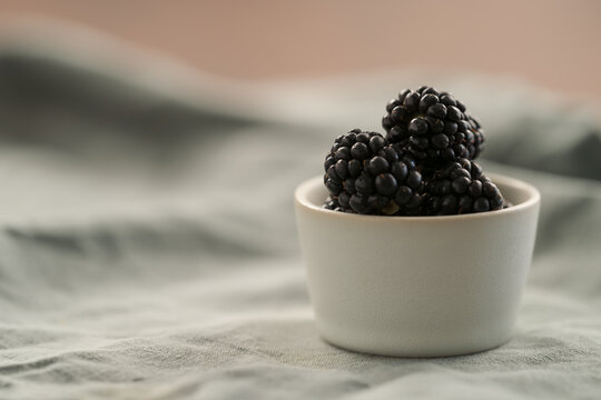 fresh ripe blackberry in a white small bowl