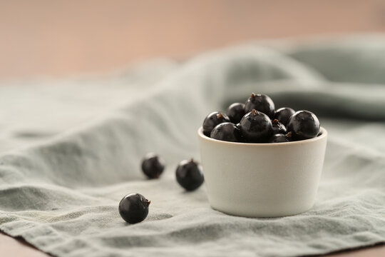 ripe blackcurrant in white ceramic bowl