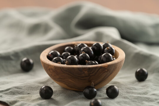 ripe blackcurrant in wood ceramic bowl
