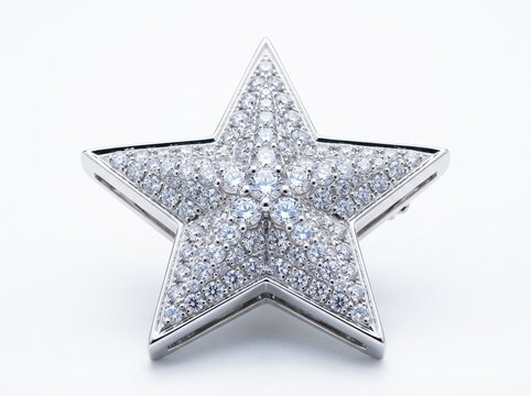 Elegant silver star brooch encrusted with sparkling clear gemstones on a clean white background