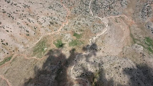 Taurus Mountains near Antalya, Turkey show maquis terrain, rocky slopes, and sparse summer shrubs. Mediterranean geography and dry ridges create a rugged warm highland scene.