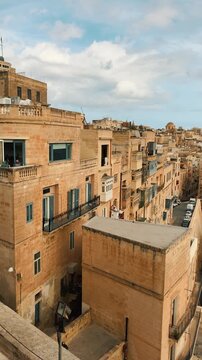  Historic streets and iconic architecture in Valletta, Malta, featuring Victoria Gate, vintage Bedford bus, ancient fortifications, and people exploring the vibrant European island capital on segways 
