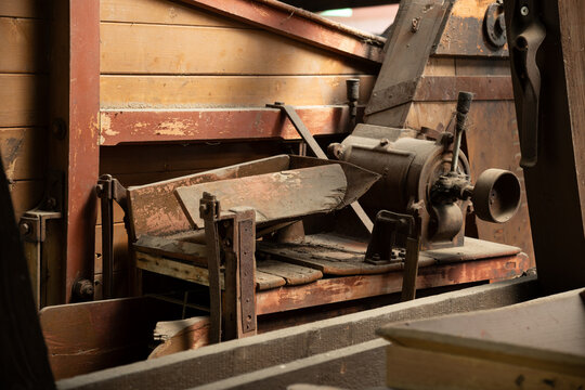 Close-up of a part of an old threshing machine outdoors.
