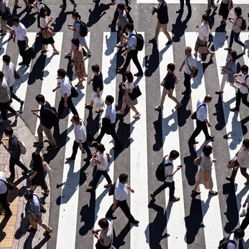 Aerial View of Crowd Crossing Busy Urban Pedestrian Crosswalk