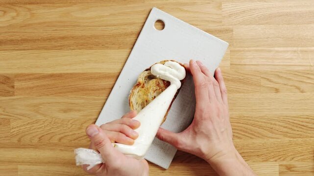 Chef pipes whipped ricotta onto toasted bread. Creamy cheese makes light breakfast base with fruit, honey or nuts. Add pear, berries, figs, prosciutto or herbs for sweet and savoury toast toppings.