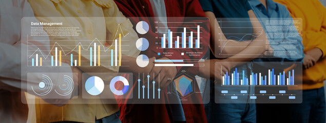 A diverse team analyzes vibrant graphs and charts on digital screens, showcasing data management...