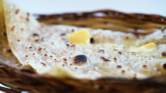Naan bread on dark background close-up. Paratha and roti. Indian bread 4K video. Chapati and butter naan.