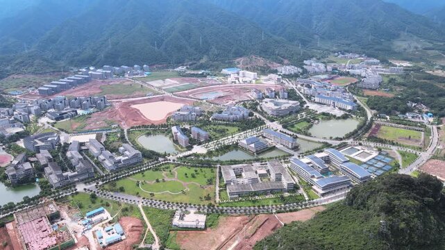 Modern University Campus Surrounded by Green Mountains