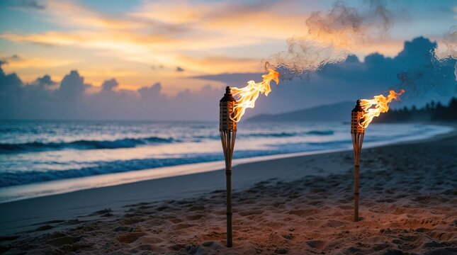 Burning bamboo torches stand on sandy beach at sunset. Warm fire flames glow against orange sky, ocean waves. Tropical coast landscape at dusk creates peaceful vacation mood. Evening light