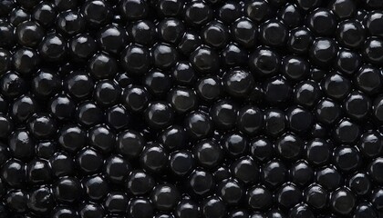 Obraz premium Detailed Macro Photograph of Glossy Black Sturgeon Caviar Pearls Packed with Rich Natural Sheen