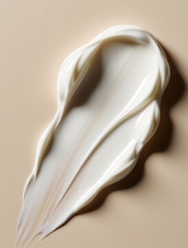 White cream smear texture abstract background. Smooth cosmetic product sample showing luxurious skincare for face and body. Beauty on beige surface.