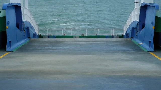 Ferry ramp lowering slowly onto a concrete slipway