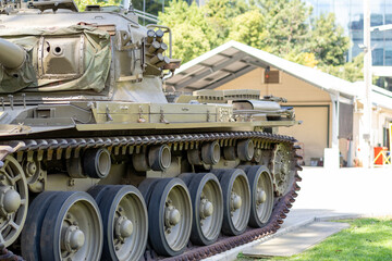 Side profile of historic military tank showing continuous tracks and turret © Em Neems Photography